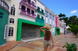 © zigres - Young traveler woman visiting the colorful Vila Cuiabana in Cuiaba City, Mato Grosso, Brazil