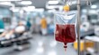 © pvl0707 - Red liquid in IV bag hangs on stand in operating room as doctor works with patient in blurred background during medical procedure