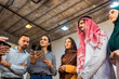 © Mediteraneo - Professional greeting between an Arab male executive and his corporate colleagues. Handshake in a bright office setting representing international business relations