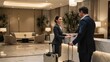© olga_demina - A receptionist in a hotel lobby is assisting a guest with his luggage, providing excellent customer service in a modern and elegant environment.