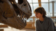 © forenna - Science museum educator crouches to child eye level beside towering dinosaur skeleton exhibit, child's jaw dropped in awe, representing paleontology education, natural history museum, STEM outreach,