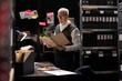 © DC Studio - Intelligence officer surrounded by confidential case files and records, interpreting surveillance photos and gathering information for a clandestine operation on organized crime.