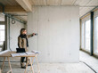 © nitinshankhwar - Architect Measuring Wall with Blueprint and Tablet in Construction Site. Engineer Planning Interior Layout Using Laser Measurement Tool