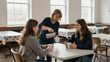 © Saranya - Woman pouring hot drink for two teenage girls at cafeteria table in warm casual scene, caring moment and relaxed conversation