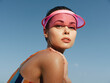 © SHOTPRIME STUDIO - Close-up portrait of a young woman wearing a pink visor, sunlit skin and glossy lips, looking confidently toward the camera with a bold summer vibe and radiant glow.