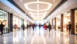 © Ca - A blurred image of a busy shopping mall interior with people walking