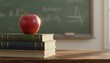 © antuanetto - Red apple for teacher on a stack of books in a classroom for Teacher's Day, showcasing an education and appreciation concept with warm lighting and a blurry chalkboard