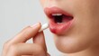 © Gerard - Close up woman taking capsule supplement daily routine