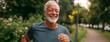 © Snowstudio - Senior man jogging in the park with a cheerful smile