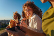 © bernardbodo - Diverse friends laughing eating pizza outdoors at sunset