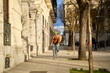 © Oscar - Courier cycling delivering packages in urban city