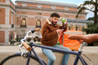© Oscar - Courier delivering food taking a coffee break in madrid