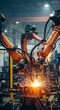 © MdNazim - Industrial robotic arms performing orange spark welding in factory