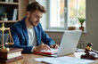 © Pete - Lawyer in blue jacket works with laptop computer and documents at desk. Scales of justice and gavel symbolize legal profession. Pro legal consultation and business law.