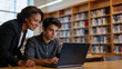 © redtiger9 - Senior Woman Guiding Young Man Studying in Knowledge Repository