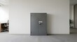 © ravikanth - Grey metal security cabinet standing against white wall in modern office interior with desk and chair in background during business hours providing professional document storage solutions.