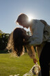 © Anna - loving couple embraces and kisses at sunset, backlit by the sun's rays. A simple, sensual, and tender shot of the bride and groom. A moment of intimacy between a man and a woman in love