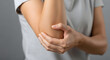 © mohamed - Woman holding her elbow in pain, injured arm. Generative AI