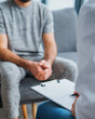 © MagicsPhotos - Man consulting doctor in modern minimal clinic