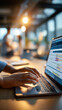 © Kateryna - Close up of a hand on a laptop showing a project management dashboard with workflow execution panels and team project tracking metrics warm office lighting defocused bright