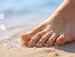 © Katerina - Macro close-up of a sandy foot with water droplets touching the shoreline under soft sunlight. Perfect for summer, wellness, and sensory beach lifestyle concepts.