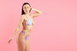 © New Africa - Beautiful woman in stylish swimsuit posing on pink background. Space for text