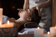© New Africa - Beautiful woman receiving facial massage in salon, closeup