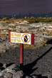 © Katrin - Bilingual No Entry Warning Sign at Laguna Colorada Nature Reserve Shoreline, Bolivia