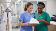 © Morrina - International Nurses Day nurses handover shift discussing patient care teamwork collaboration professional healthcare medical communication hospital celebration editorial magazine content