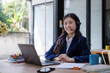 © crizzystudio - Young asian woman providing customer support smiling