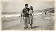 © Cliff - Old faded black and white photo of a couple in love on a summer vacation at the sea