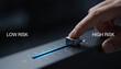 © Nattapol - Human hand adjusts glowing risk slider, shifting low to high. Business strategy decision, finance control, modern digital technology progress
