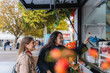 © Westend61 - Friends smiling and buying street food at a truck in autumn city