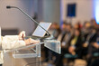 © wellphoto - Female public speaker at business conference, corporate presentation, workshop, coaching training, news conference, company meeting, public or political event. Public speaking concept.