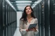 © sogap - hispanic female it engineer holding tablet in data center corridor