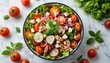 © jollier_ - Fresh salad with tomatoes, radishes, and lettuce in a bowl on a marble table with herbs nearby