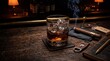 © Aan - A close-up of a whiskey glass with ice and a smoking cigar on a rustic wooden bar.
