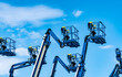 © Fahroni - Articulated boom lift. Aerial platform lift. Telescopic boom lift against blue sky. Mobile construction crane for rent and sale. Maintenance and repair hydraulic boom lift service. Crane dealership.