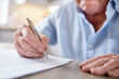 © peopleimages.com - Hand, old man and writing on document in home for signature, agreement and financial contract. Senior person, paperwork and compliance form with loan application, retirement fund and asset management
