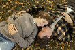 © Anna - cute young couple lies on the fallen leaves, smiling lovingly and talking about their feelings. Happy and relaxed, planning life projects such as marriage, a shared future