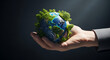 © OmurFaruk - A suited individual carefully holds a small Earth teeming with abundant green trees.