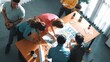 © InfiniteFlow - Top view of smart manager writing at blueprint while marketing team plans design. Aerial view of architect engineer working together sharing idea and taking a note in project plan at table. Symposium.
