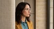 © Viktoria - Profile portrait of a woman in architectural eyewear looking through a window. Natural light highlights the sharp jawline and textured blazer. Atmosphere of profound thought and leadership.