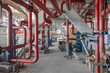© Marco Reggi/Stocksy - Industrial interior with red pipes in a mechanical room