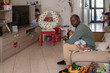 © Anna Fedorova/Stocksy - Thoughtful father resting with his sleeping child in the living room