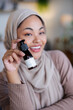 © Jovo Jovanovic/Stocksy - Woman in hijab promotes organic skincare product.