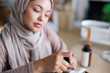 © Jovo Jovanovic/Stocksy - Woman in hijab prepares essential oils.