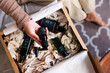 © Jovo Jovanovic/Stocksy - Woman unpacking a box of organic skincare products.