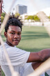 © Jovo Jovanovic/Stocksy - Happy young athlete resting at soccer goal