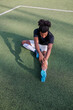 © Jovo Jovanovic/Stocksy - Soccer player stretches on the field before a game